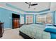 Main bedroom with a tray ceiling and large windows at 10511 Mistflower Ln, Tampa, FL 33647