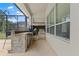 Elegant outdoor kitchen with stone accents and built-in appliances for grilling and entertaining in style at 10511 Mistflower Ln, Tampa, FL 33647