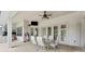 Spacious covered patio featuring a ceiling fan and an outdoor dining area for entertaining guests at 10511 Mistflower Ln, Tampa, FL 33647