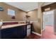 A well-equipped Personal cave with a popcorn machine and convenient snack bar, leading to another room at 10511 Mistflower Ln, Tampa, FL 33647