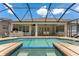 Inviting pool and spa with a screened enclosure, creating a private and relaxing outdoor retreat at 10511 Mistflower Ln, Tampa, FL 33647