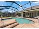 Sparkling pool and spa surrounded by a screened enclosure, providing a resort-like experience in your own backyard at 10511 Mistflower Ln, Tampa, FL 33647