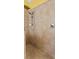 Walk-in shower featuring beige tile surround, a shower head, handheld sprayer and a tile border at 10511 Mistflower Ln, Tampa, FL 33647