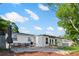 Backyard with patio seating and outdoor grill with lush foliage at 1099 7Th Ne Ave, Largo, FL 33770