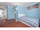 Comfortable bedroom with hardwood floors, ample natural light, and blue wall at 1099 7Th Ne Ave, Largo, FL 33770