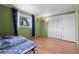 Spacious bedroom with hardwood floors, bright walls, white closet door, and natural light at 1099 7Th Ne Ave, Largo, FL 33770