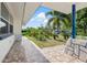 Relaxing covered porch view with stone accents and lush landscaping creating a welcoming atmosphere at 1099 7Th Ne Ave, Largo, FL 33770