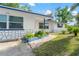 Home with blue accents, stone veneer, and charming landscaping enhancing its street appeal at 1099 7Th Ne Ave, Largo, FL 33770