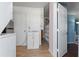 Open hallway with storage cabinets and access to the bedroom with blue walls at 1099 7Th Ne Ave, Largo, FL 33770