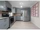 Well-lit kitchen with stainless steel appliances, ample cabinet space, and updated countertops at 1099 7Th Ne Ave, Largo, FL 33770