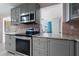 Bright kitchen with stainless steel appliances, modern countertops, and neutral cabinets at 1099 7Th Ne Ave, Largo, FL 33770