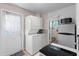 Convenient kitchenette with stackable washer/dryer and access to the bathroom at 1099 7Th Ne Ave, Largo, FL 33770