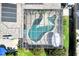 Aerial view of a screened-in swimming pool surrounded by lush landscaping, patio area, and an unique shape at 1220 Pinellas Point S Dr, St Petersburg, FL 33705