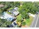 Aerial view of a home with a backyard pool and a screened-in lanai in a treed neighborhood at 1220 Pinellas Point S Dr, St Petersburg, FL 33705