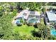 Aerial view of a single-Gathering home with solar panels, pool, lanai, and private backyard at 1220 Pinellas Point S Dr, St Petersburg, FL 33705