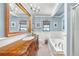 Charming bathroom featuring elegant blue paint, stylish fixtures, tub, shower and ample lighting at 1220 Pinellas Point S Dr, St Petersburg, FL 33705