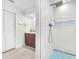 Luxurious bathroom featuring a walk-in shower with blue mosaic tile and white tile walls at 1220 Pinellas Point S Dr, St Petersburg, FL 33705