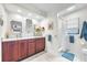 Stylish bathroom showcasing double sinks, elegant wallpaper, and modern fixtures at 1220 Pinellas Point S Dr, St Petersburg, FL 33705