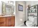 Charming bathroom with decorative mirror, granite counters and decorative shelving at 1220 Pinellas Point S Dr, St Petersburg, FL 33705