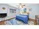 Comfortable bedroom with a ceiling fan, blue accent wall and a large window providing natural light at 1220 Pinellas Point S Dr, St Petersburg, FL 33705