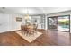 Dining area with wood table, hardwood floors and views of the outdoor pool at 1220 Pinellas Point S Dr, St Petersburg, FL 33705