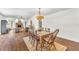 Sunlit dining room featuring hardwood floors, area rug, chandelier, and ample natural light at 1220 Pinellas Point S Dr, St Petersburg, FL 33705