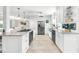 Modern kitchen featuring stainless steel appliances, white cabinetry, and a spacious island at 1220 Pinellas Point S Dr, St Petersburg, FL 33705