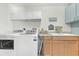 Bright laundry room features front loading washer and dryer and plenty of storage cabinets at 1220 Pinellas Point S Dr, St Petersburg, FL 33705