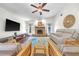 Spacious living room with stone fireplace, hardwood floors, neutral furniture, and natural light at 1220 Pinellas Point S Dr, St Petersburg, FL 33705