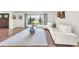 Living room with hardwood floors, bright windows, stylish white sofa, and unique coffee table at 1220 Pinellas Point S Dr, St Petersburg, FL 33705