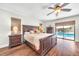 Inviting main bedroom with hardwood floors and a view of the pool at 1220 Pinellas Point S Dr, St Petersburg, FL 33705