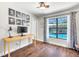 Bright home office features a desk and a window looking out to the pool area at 1220 Pinellas Point S Dr, St Petersburg, FL 33705