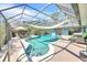 Beautiful screened in pool with chairs, and outdoor living area with overhead shade cover at 1220 Pinellas Point S Dr, St Petersburg, FL 33705