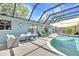 Covered outdoor pool and patio with comfortable furniture and screened-in enclosure at 1220 Pinellas Point S Dr, St Petersburg, FL 33705