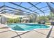 Beautiful screened-in pool with patio, overhead shade cover, and lounge chairs at 1220 Pinellas Point S Dr, St Petersburg, FL 33705