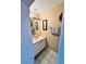 Cozy half bathroom with great lighting, a sink with a small vanity, and an interior design with art at 12367 Foxmoor Peak Dr, Riverview, FL 33579