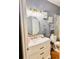 Stylish bathroom with a round mirror, vanity with marble countertop, and elegant fixtures at 12367 Foxmoor Peak Dr, Riverview, FL 33579