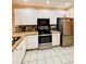 Bright kitchen with white cabinets, granite countertops, and stainless steel appliances at 12367 Foxmoor Peak Dr, Riverview, FL 33579