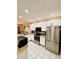 Modern kitchen featuring white cabinets, granite counters, and stainless steel appliances at 12367 Foxmoor Peak Dr, Riverview, FL 33579