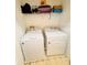 Functional laundry room featuring a washer, dryer, and storage shelf for supplies at 12367 Foxmoor Peak Dr, Riverview, FL 33579