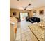 Bright living area open to the kitchen, with tile flooring, and a sliding glass door leading to the backyard at 12367 Foxmoor Peak Dr, Riverview, FL 33579