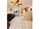 Bright living area open to the kitchen, with tile flooring, a ceiling fan and bar seating at 12367 Foxmoor Peak Dr, Riverview, FL 33579