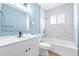 Freshly renovated bathroom with blue walls, white cabinets, and marble look shower at 1323 48Th N Ave, St Petersburg, FL 33703