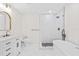 Bathroom featuring a freestanding tub, walk-in shower, and marble countertops at 1323 48Th N Ave, St Petersburg, FL 33703