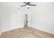 Bedroom with wood-look floors has a ceiling fan, closet, and white doors and trim at 1323 48Th N Ave, St Petersburg, FL 33703