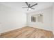 Neutral bedroom boasts natural light, wood-look floors, and a ceiling fan at 1323 48Th N Ave, St Petersburg, FL 33703