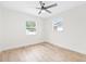 Bright bedroom features neutral walls, natural light, ceiling fan, and wood-look flooring at 1323 48Th N Ave, St Petersburg, FL 33703