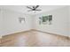 Bedroom with wood-look floors, neutral paint, ceiling fan and lots of light from two windows at 1323 48Th N Ave, St Petersburg, FL 33703