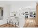 Bright kitchen features white cabinetry, stainless steel appliances, and a breakfast bar with seating at 1323 48Th N Ave, St Petersburg, FL 33703