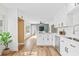 Bright modern kitchen features white cabinets, stainless steel appliances, and hardwood flooring at 1323 48Th N Ave, St Petersburg, FL 33703